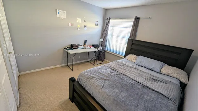 a bed sitting in a bedroom next to a window