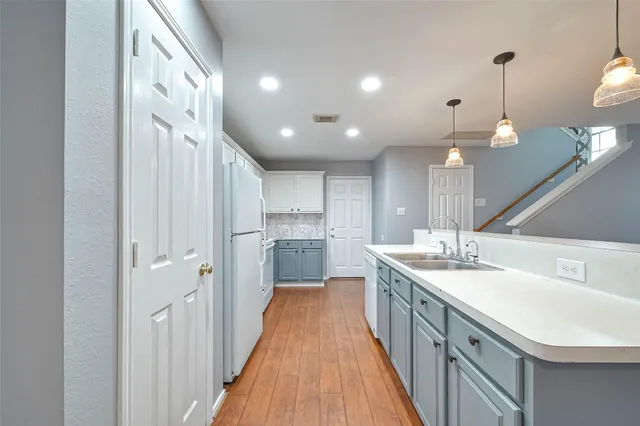 a kitchen with kitchen island a sink and stove