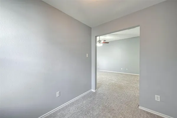 a view of a livingroom with an empty space and a window