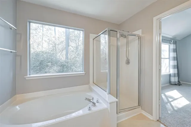 a white bath tub sitting next to a window
