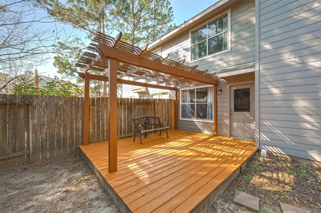 a view of a patio with a table chairs and wooden fence