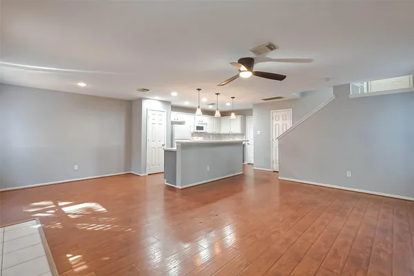 a view of a kitchen with a sink and a kitchen island