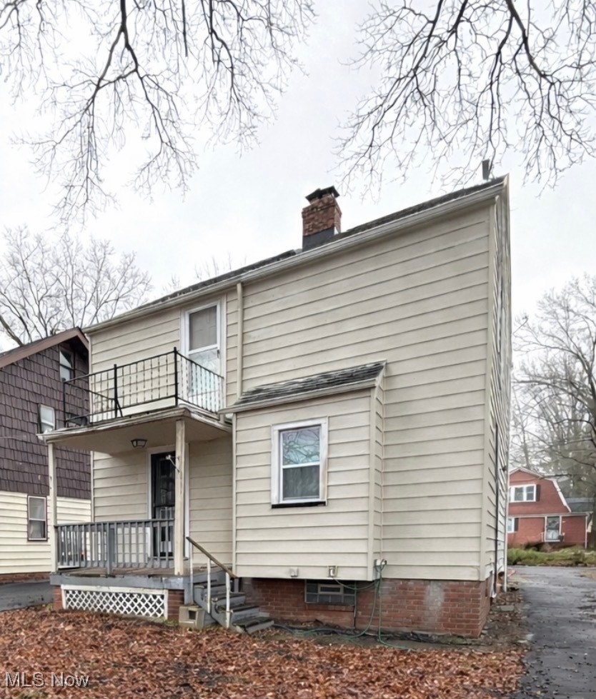 994 Yellowstone Road Cleveland Heights, OH 44121 - Photo 14 of 15 Rear view of house featuring a chimney and a balcony