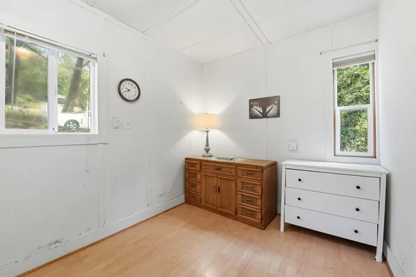 a room with window and dresser