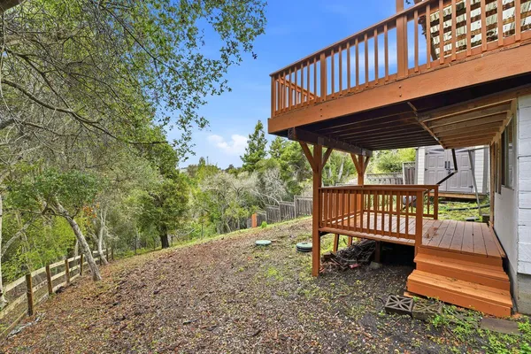 a view of a roof deck with a small yard