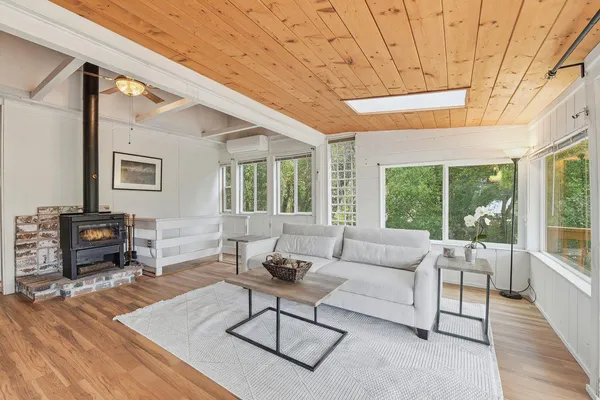 a living room with furniture a table and a large window