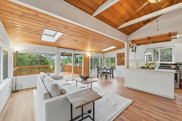 a living room with furniture and large windows