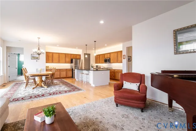 a living room with furniture and a dining table with kitchen view