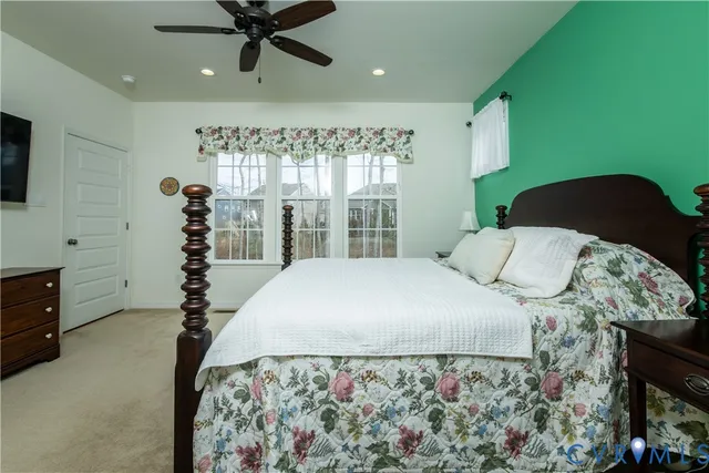 a bed sitting in a bedroom next to a window