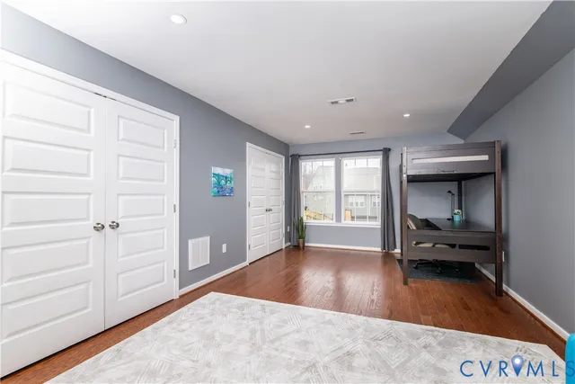 a view of a livingroom with wooden floor and furniture