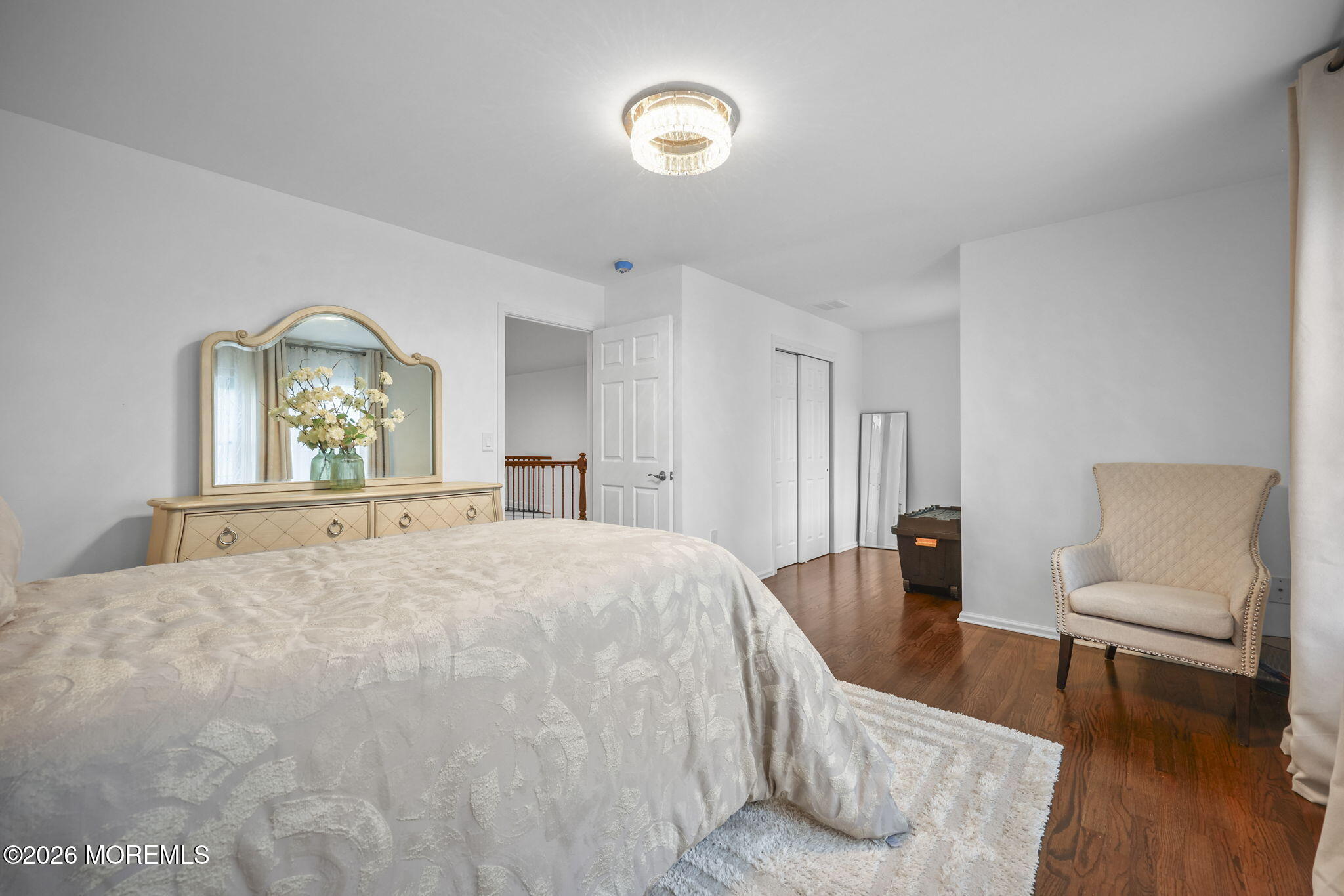 29 Chad Lane Howell, NJ 07731 - Photo 29 of 44 a spacious bedroom with a bed and a chair