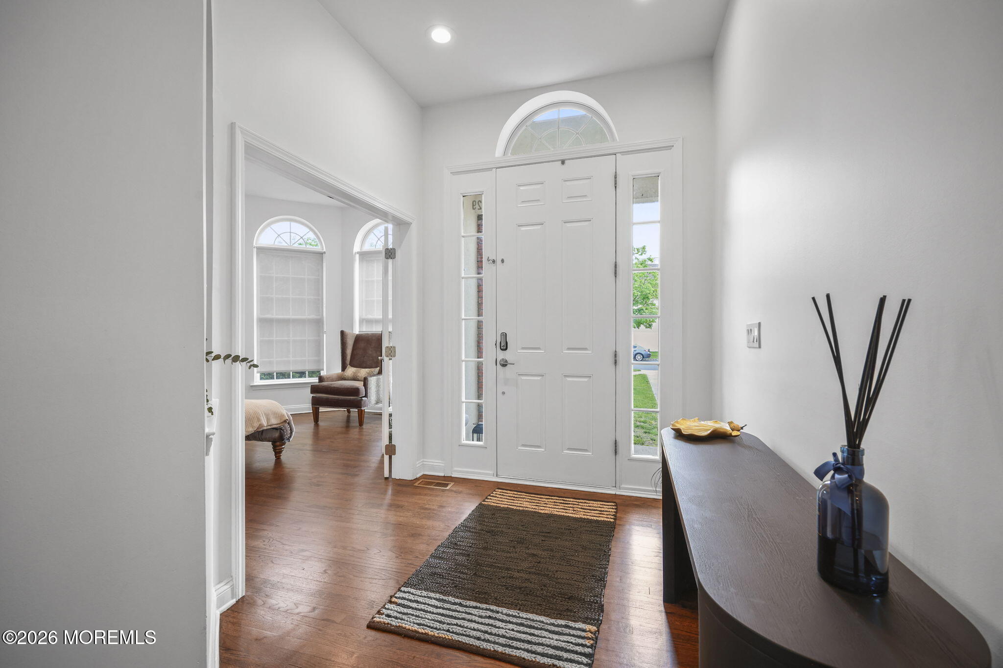 29 Chad Lane Howell, NJ 07731 - Photo 6 of 44 wooden floor with windows and view of kitchen