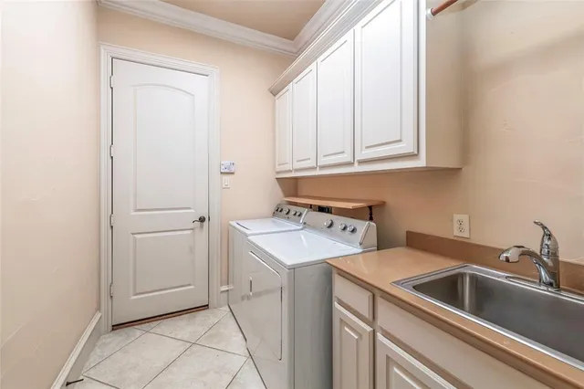 a utility room with sink dryer and washer