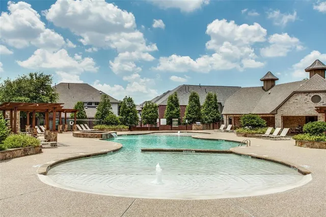 a view of a swimming pool with outdoor seating