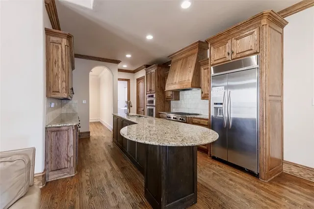a kitchen with refrigerator and cabinets