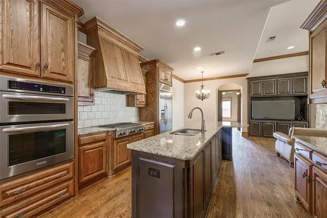 a kitchen with granite countertop a stove and a sink