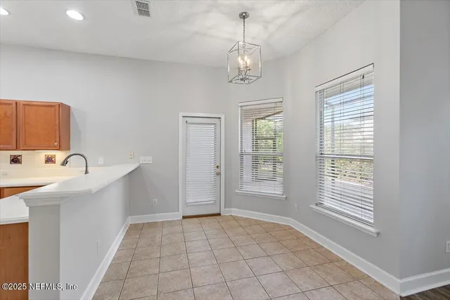 a living room with furniture a fireplace and a large window