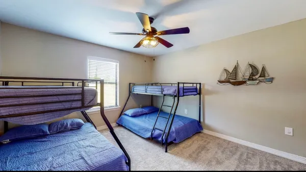 a bedroom with furniture and a ceiling fan