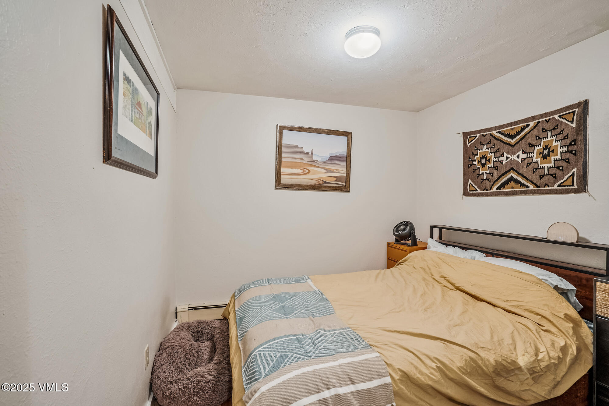 2487 Chamonix Lane, Unit F1 Vail, CO 81657 - Photo 15 of 27 a bedroom with a bed and a painting on the wall