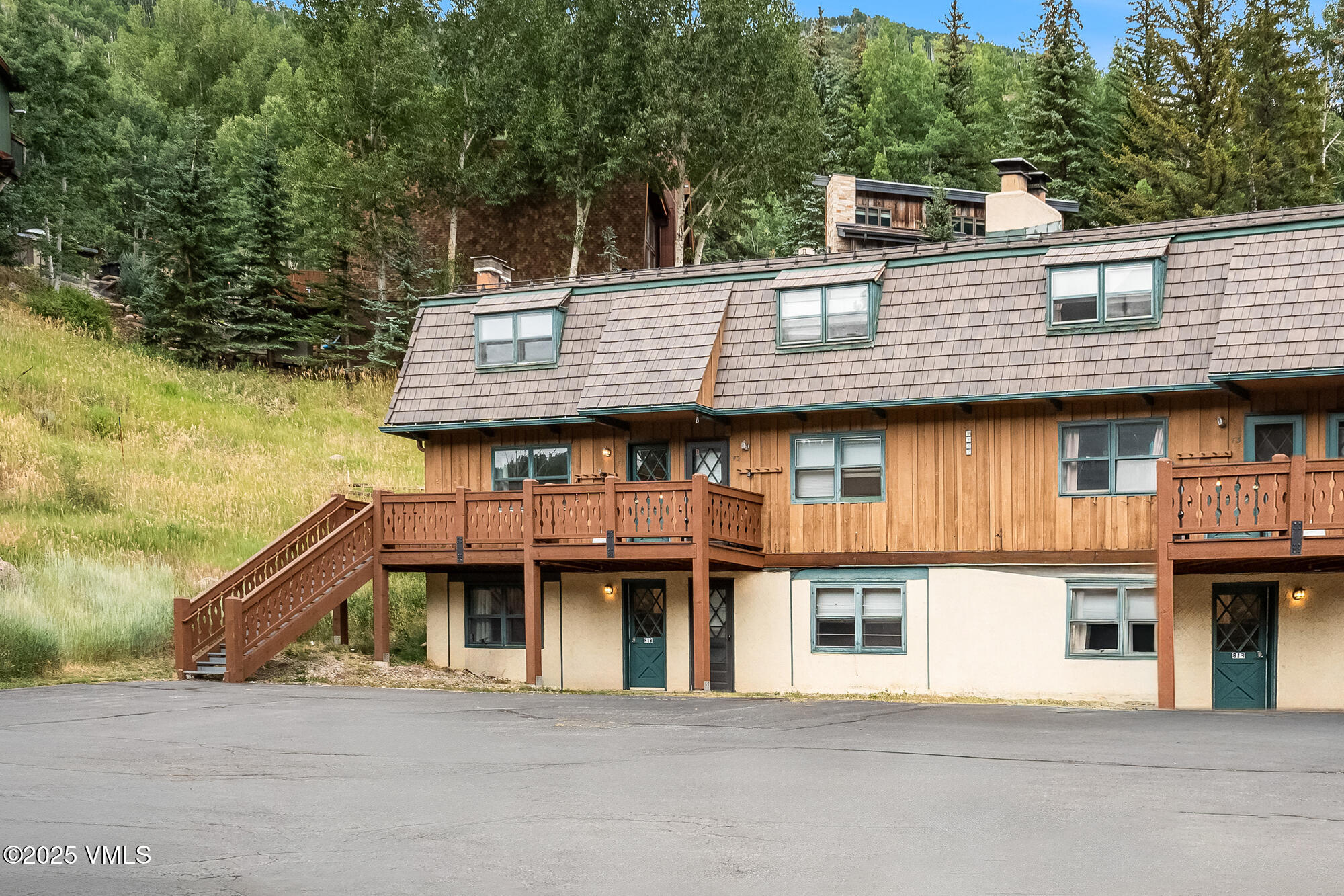 2487 Chamonix Lane, Unit F1 Vail, CO 81657 - Photo 17 of 27 a front view of a house with a garden