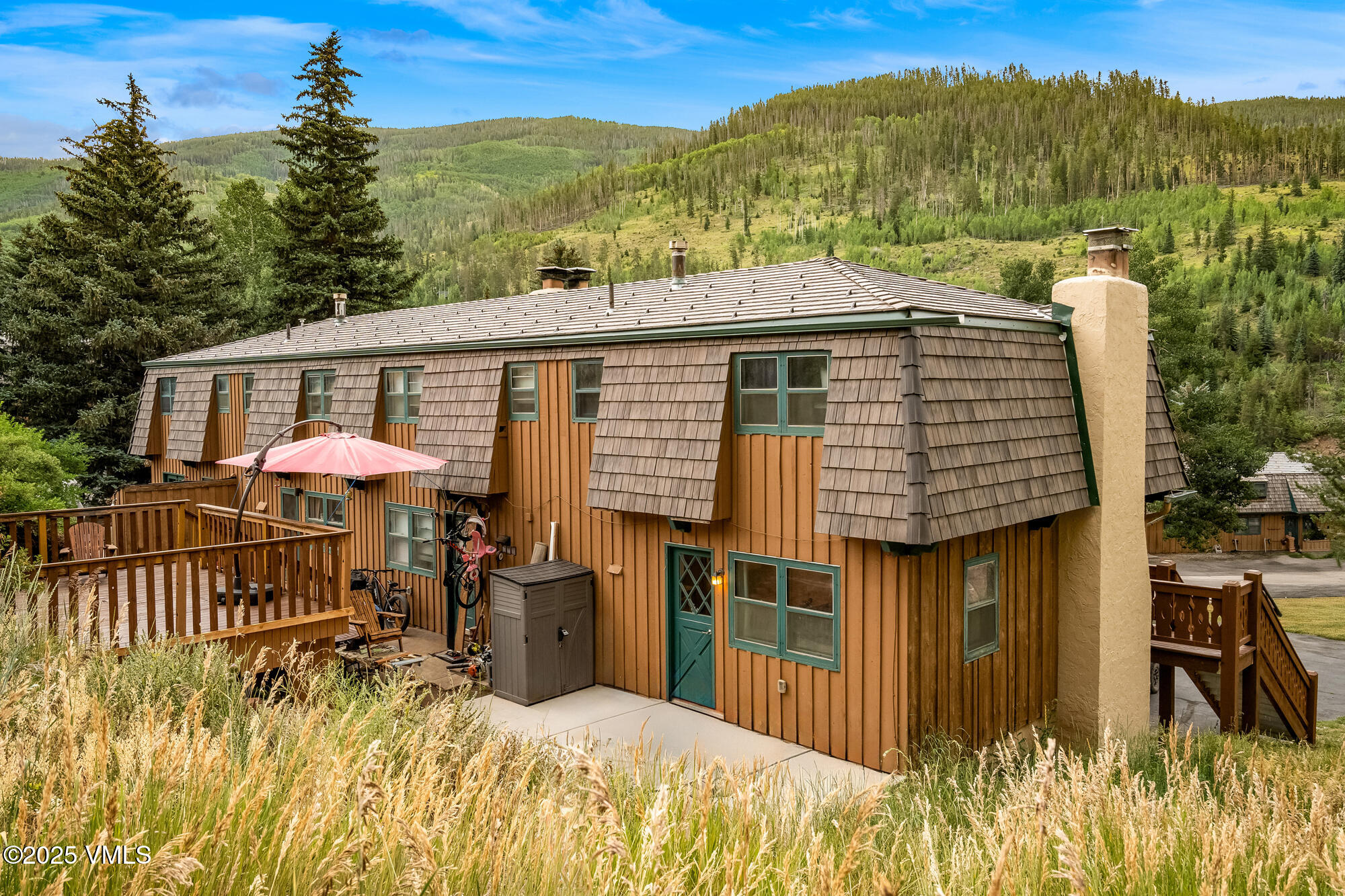 2487 Chamonix Lane, Unit F1 Vail, CO 81657 - Photo 20 of 27 a view of a patio with a table chairs and a table