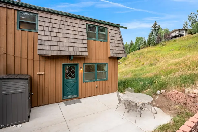 a view of a house with backyard and sitting area