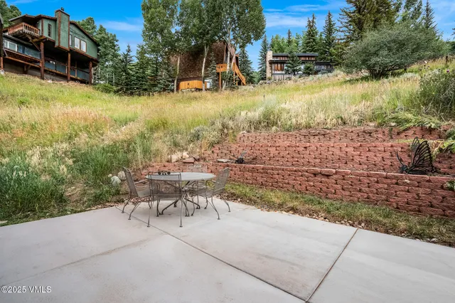 a view of a patio with chairs and a yard
