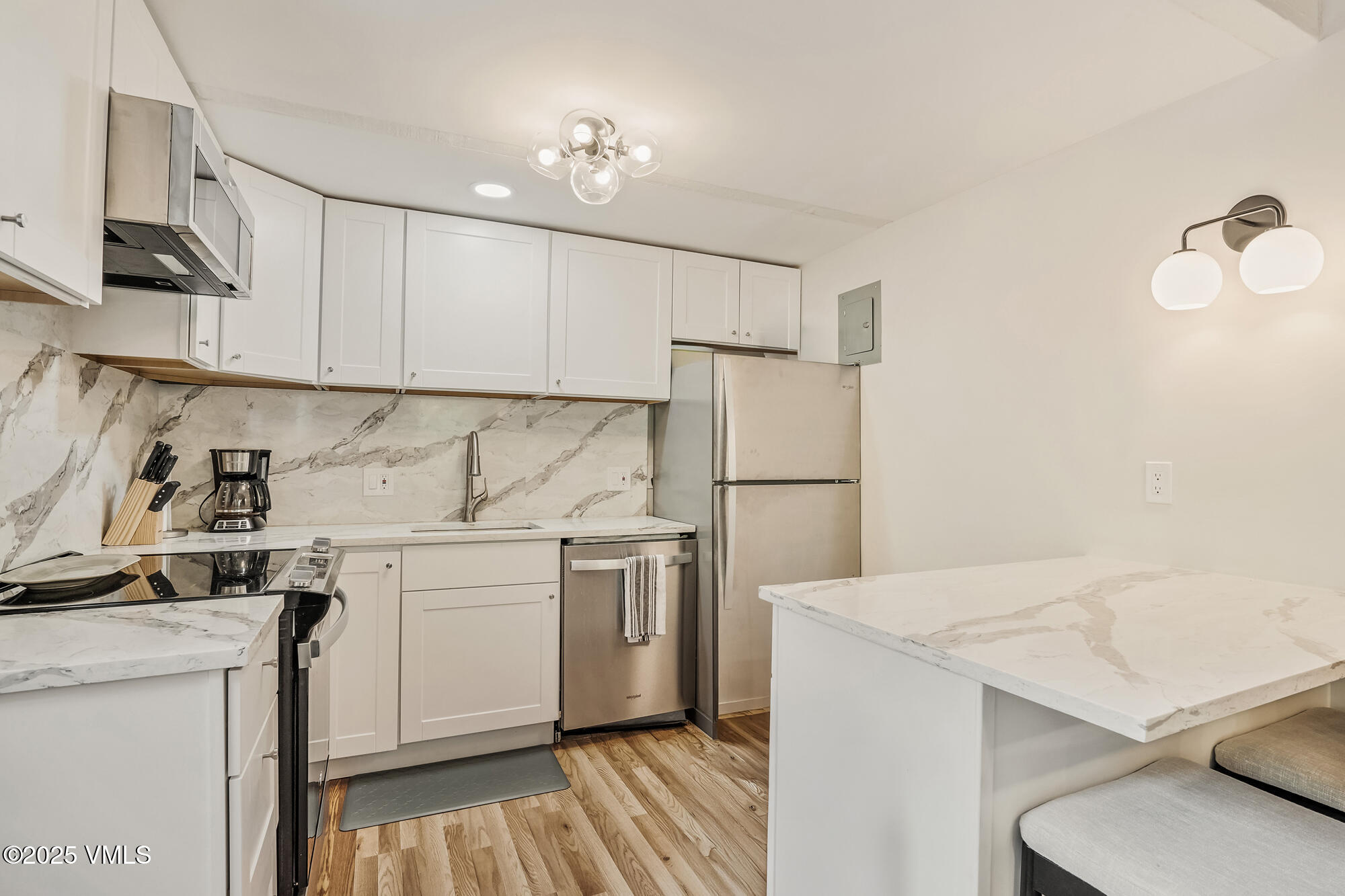 2487 Chamonix Lane, Unit F1 Vail, CO 81657 - Photo 6 of 27 a kitchen with a sink a refrigerator and cabinets