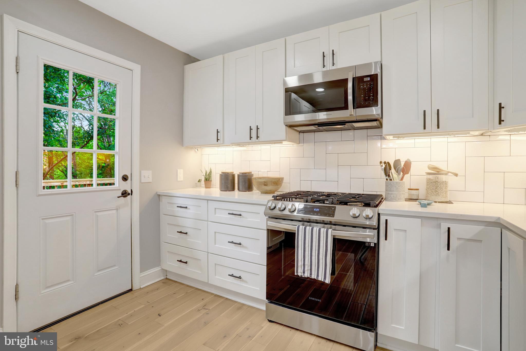 5418 Inverchapel Road Springfield, VA 22151 - Photo 15 of 94 a kitchen with stainless steel appliances a stove a microwave and cabinets