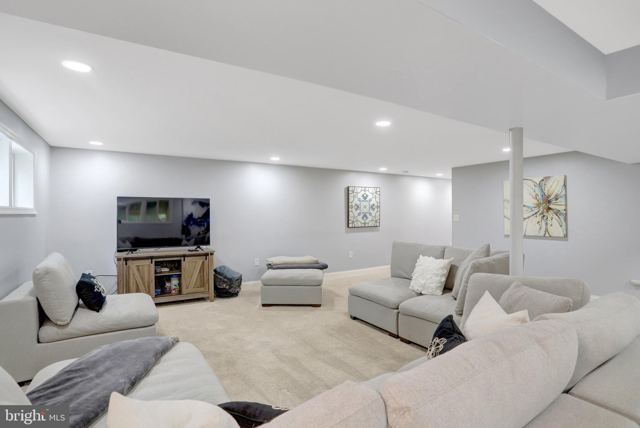 5418 Inverchapel Road Springfield, VA 22151 - Photo 46 of 94 a living room with furniture and a flat screen tv