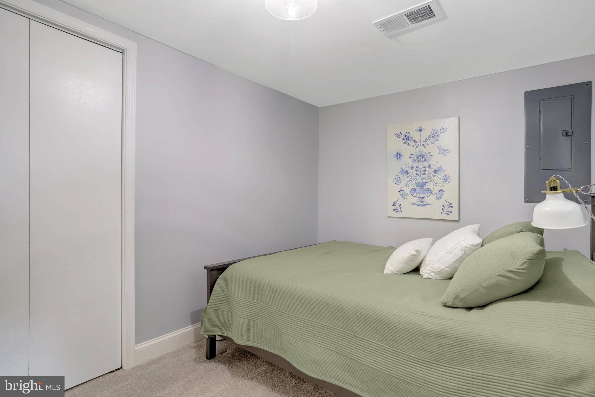 5418 Inverchapel Road Springfield, VA 22151 - Photo 48 of 94 a bedroom with a bed and painting on the wall