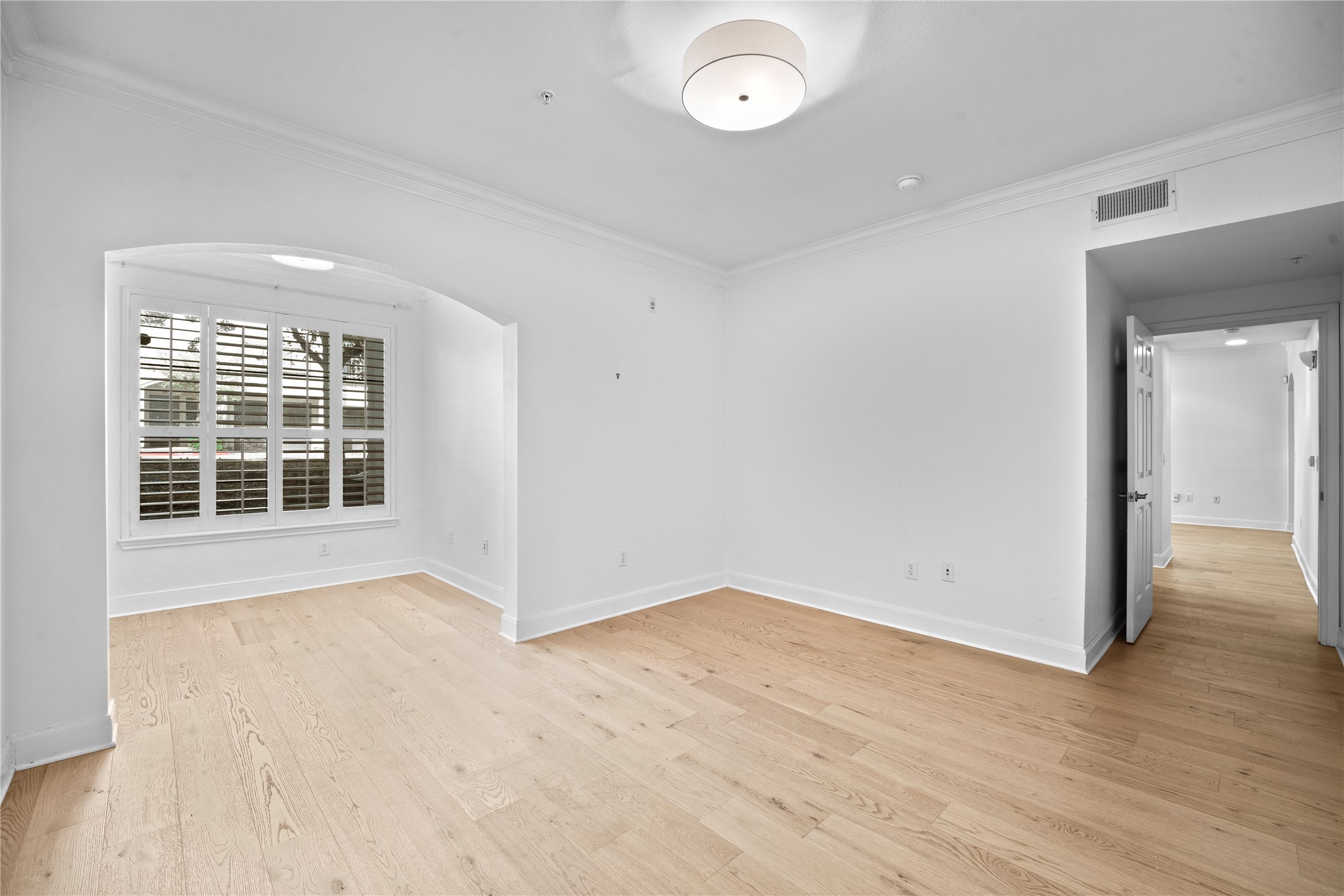 7701 Rialto Boulevard, Unit 1412 Austin, TX 78735 - Photo 17 of 30 an empty room with wooden floor and windows