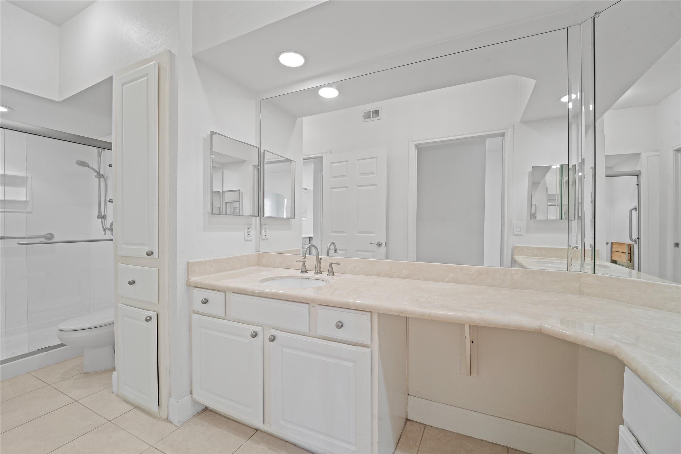 7701 Rialto Boulevard, Unit 1412 Austin, TX 78735 - Photo 20 of 30 a bathroom with a granite countertop sink mirror and toilet