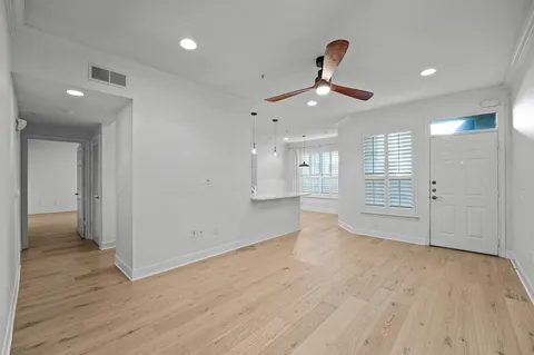 a view of an empty room and wooden floor