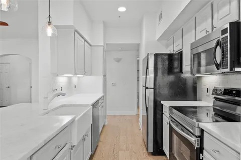 a kitchen with a sink stove and refrigerator