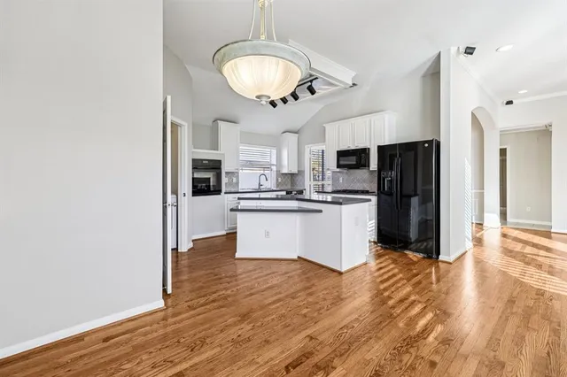 a view of kitchen with refrigerator microwave and cabinets