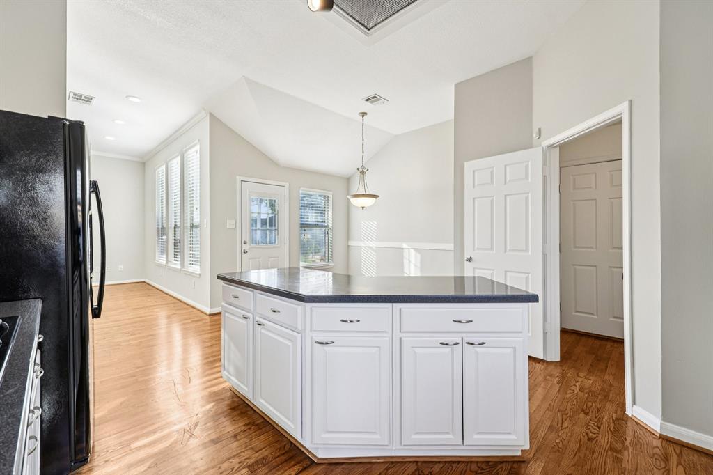 7313 San Carlos Drive Rowlett, TX 75089 - Photo 20 of 40 a kitchen with white cabinets and stainless steel appliances
