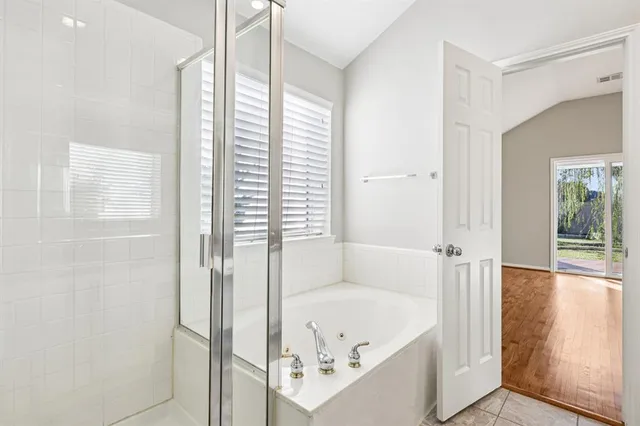 a bathroom with a bathtub and a shower