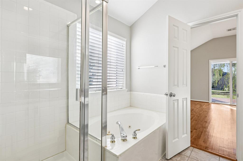 7313 San Carlos Drive Rowlett, TX 75089 - Photo 26 of 40 a bathroom with a bathtub and a shower