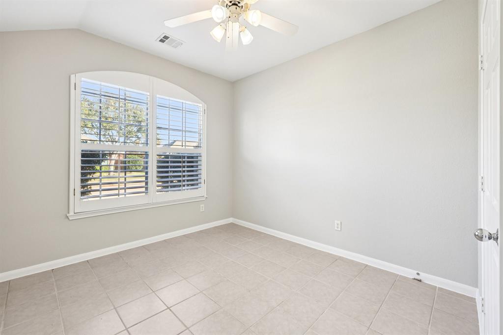7313 San Carlos Drive Rowlett, TX 75089 - Photo 29 of 40 an empty room with a chandelier fan and windows