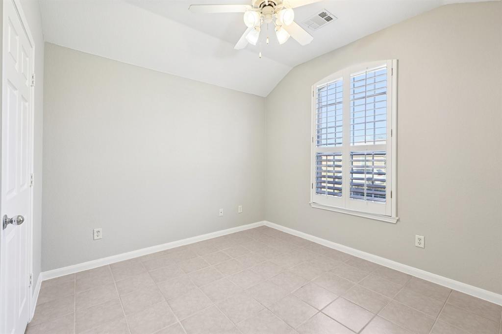 7313 San Carlos Drive Rowlett, TX 75089 - Photo 31 of 40 an empty room with a chandelier fan and windows
