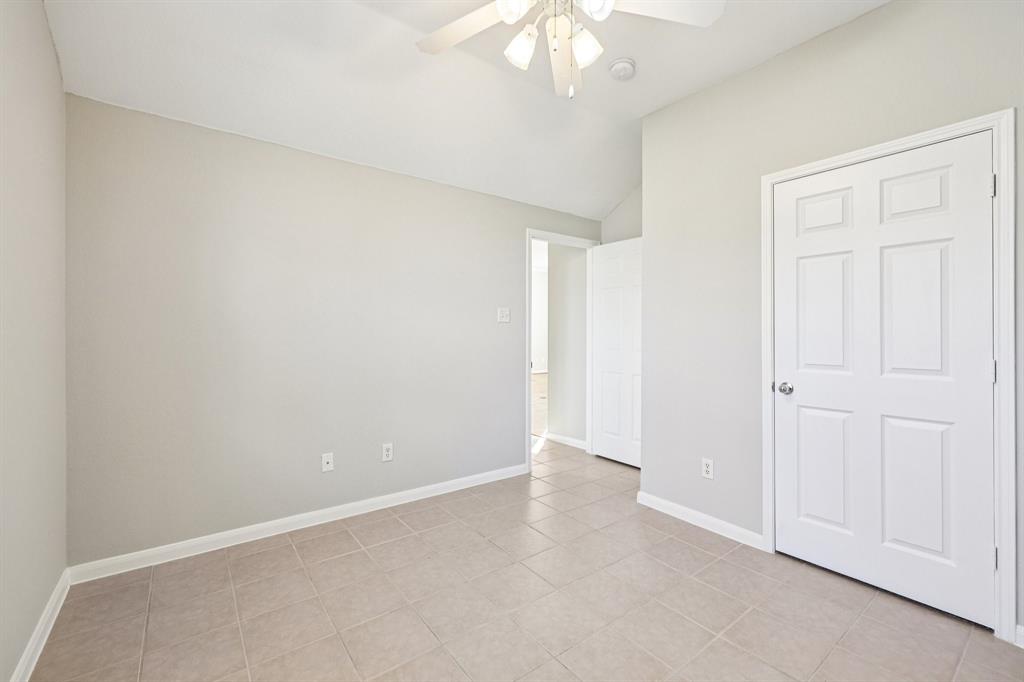 7313 San Carlos Drive Rowlett, TX 75089 - Photo 32 of 40 an empty room with a chandelier fan