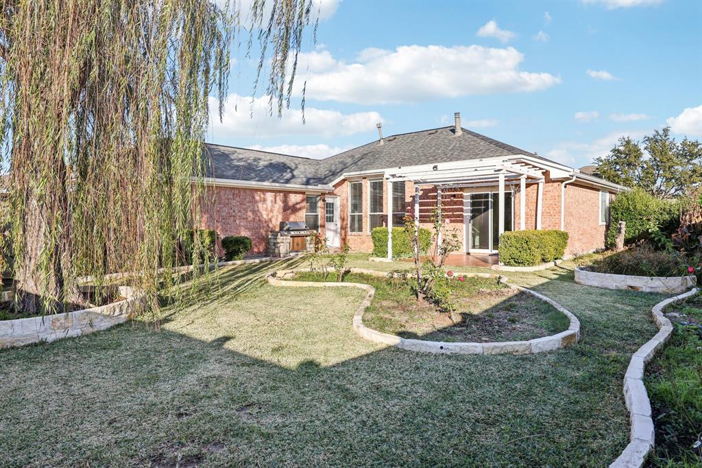 7313 San Carlos Drive Rowlett, TX 75089 - Photo 37 of 40 a view of a house with backyard and sitting area