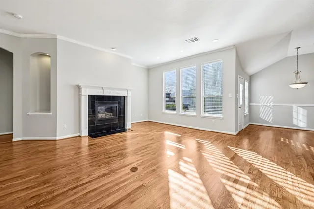 a view of an empty room with window and fire place