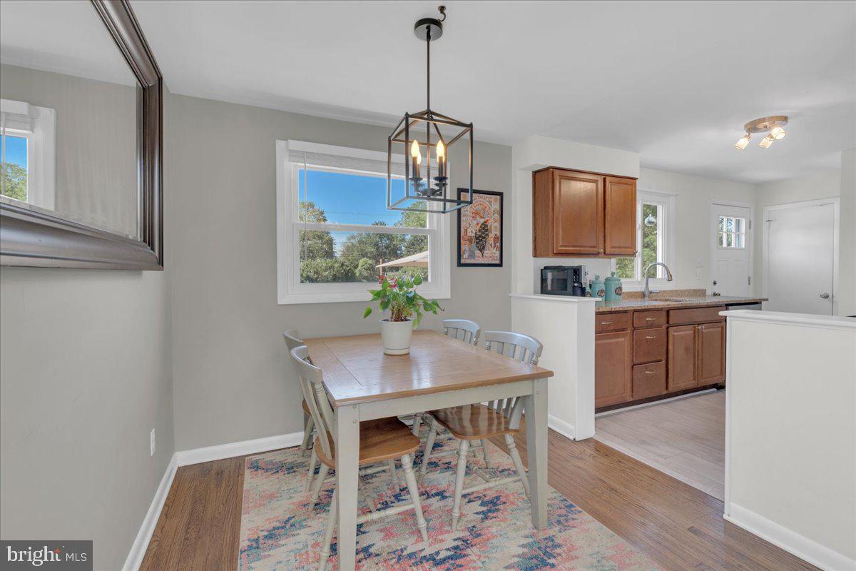 166 Sproul Road Malvern, PA 19355 - Photo 4 of 20 a kitchen with stainless steel appliances a dining table chairs and granite counter tops