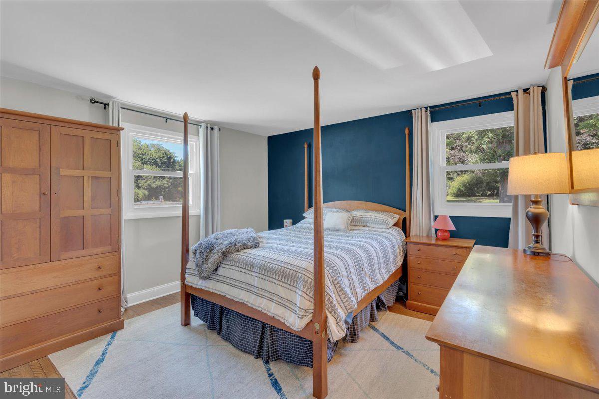 166 Sproul Road Malvern, PA 19355 - Photo 9 of 20 a bedroom with a bed and wooden floor