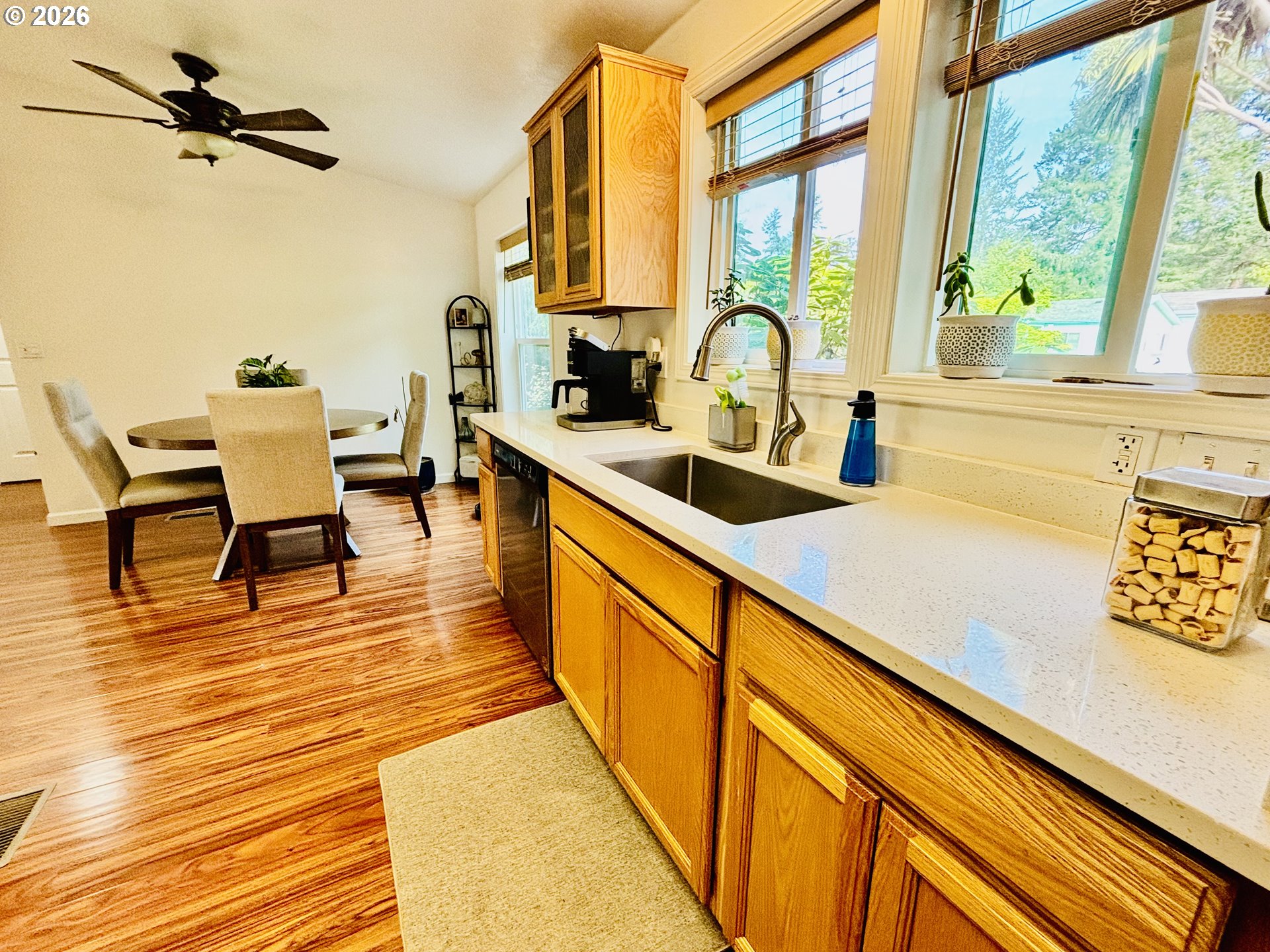 98190 Gavin Lane Brookings, OR 97415 - Photo 13 of 37 a view of a kitchen with kitchen island a large window a sink and appliances