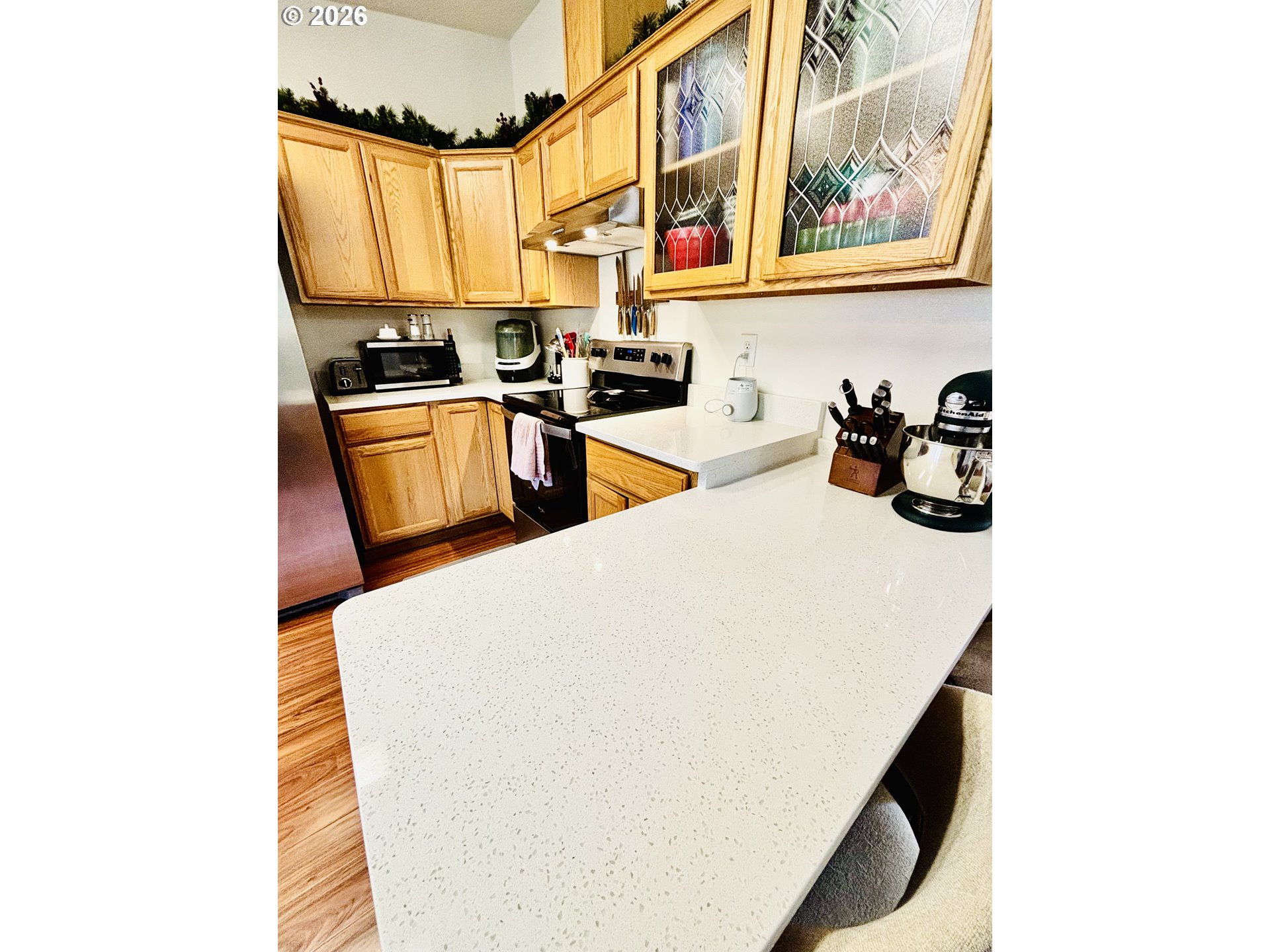 98190 Gavin Lane Brookings, OR 97415 - Photo 17 of 37 a kitchen with stainless steel appliances a sink a stove and a refrigerator