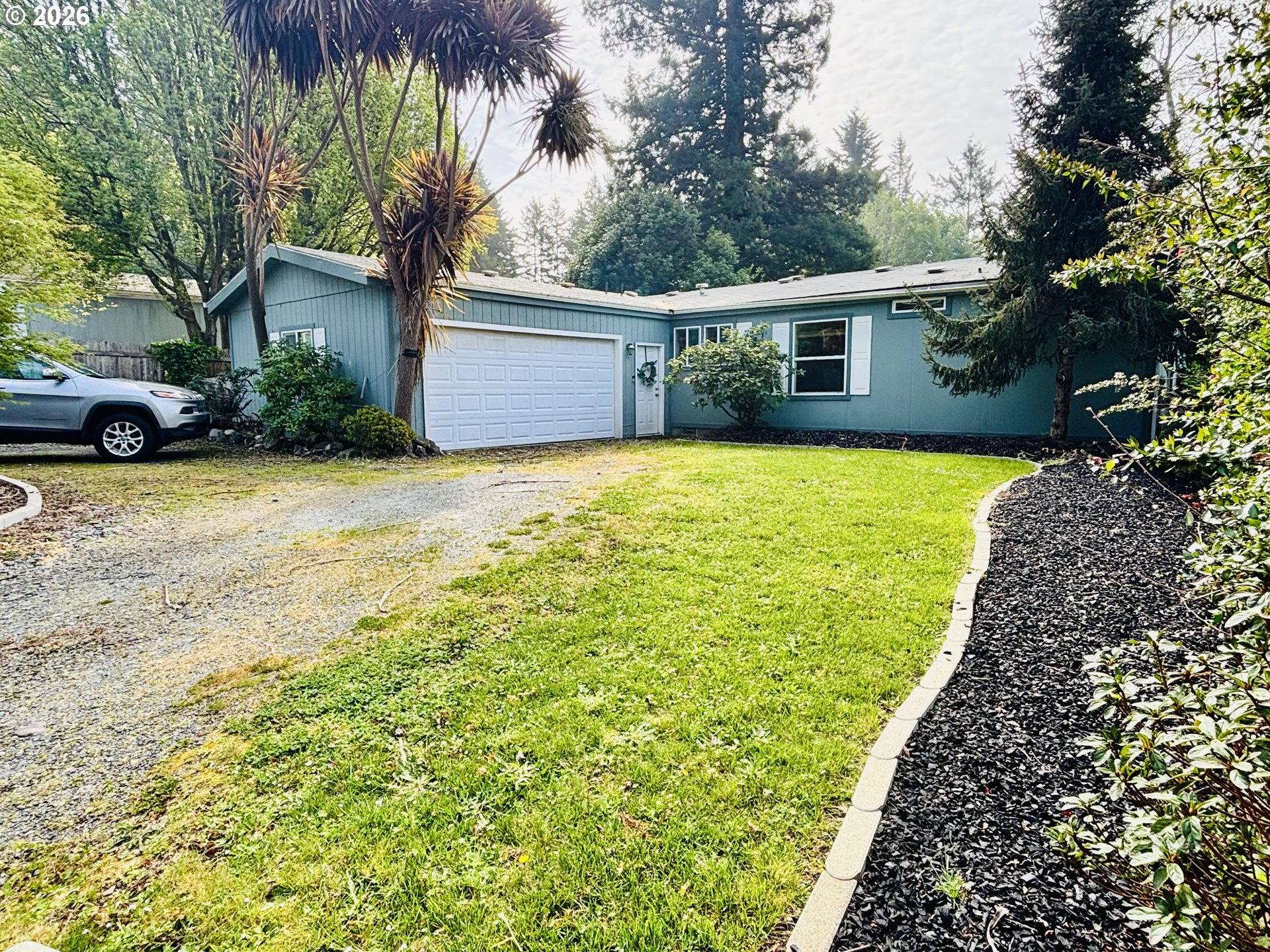 98190 Gavin Lane Brookings, OR 97415 - Photo 2 of 37 a front view of a house with garden