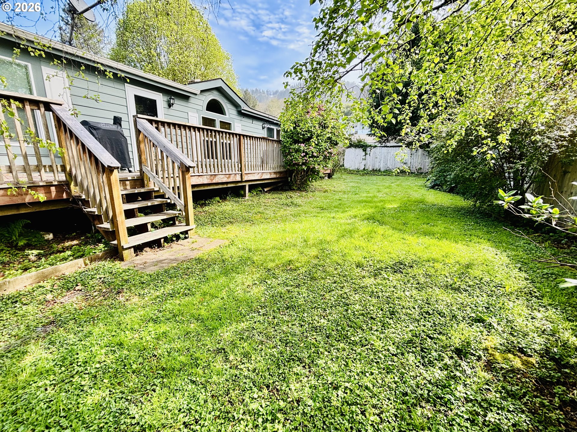 98190 Gavin Lane Brookings, OR 97415 - Photo 4 of 37 a view of a house with a big yard plants and large trees